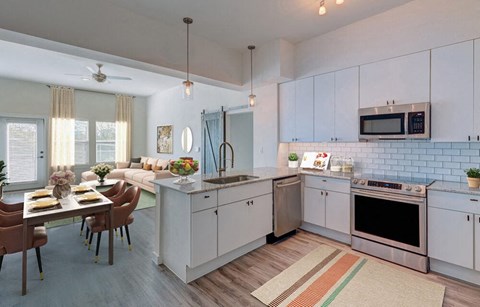 a kitchen and living room with a table